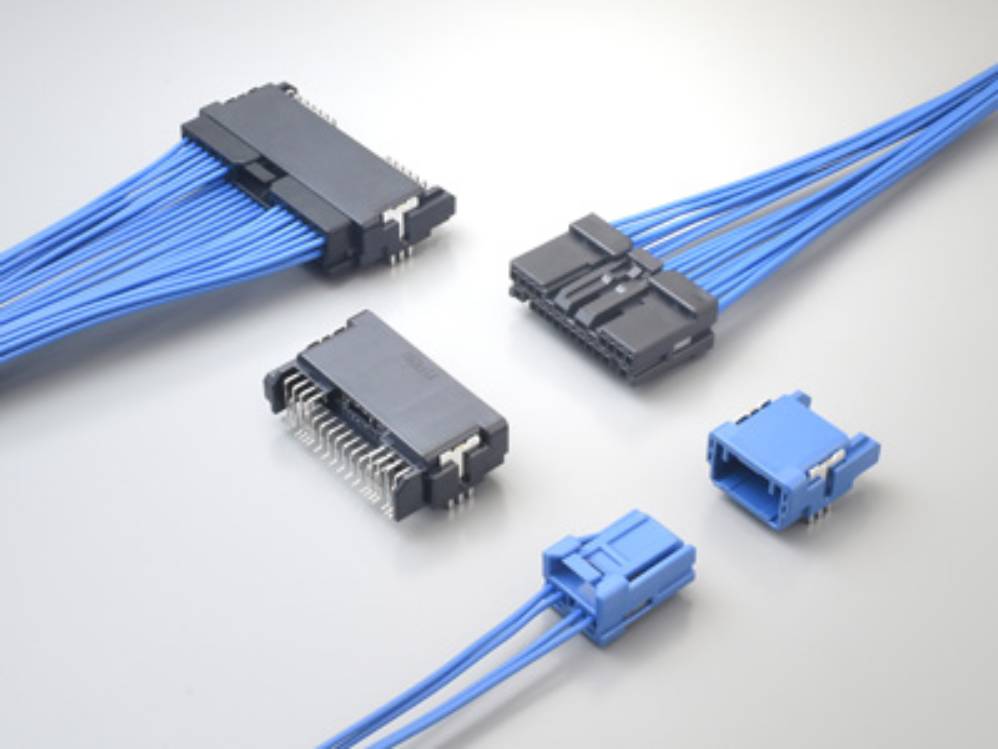 Five connectors with blue cables arranged on a light background, indicating electronic components for wiring and assembly.