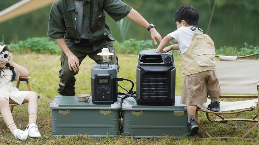 A man helps a child with camping equipment near a serene lake, showcasing a lantern and a portable cooler on green boxes.