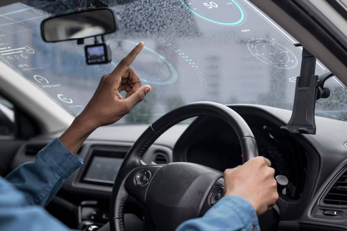 A driver interacts with a digital dashboard display projected onto the windshield, showcasing speed and other driving metrics.
