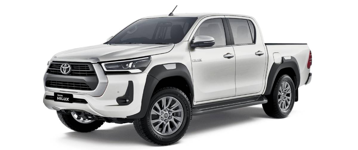 A sleek white Toyota Hilux pickup truck, showcasing its modern design and robust stance, parked at a slight angle.