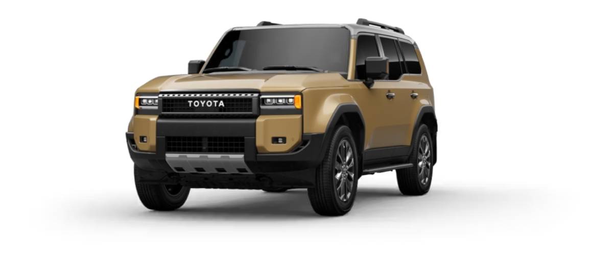 A front view of a rugged beige Toyota SUV featuring bold design elements, black accents, and modern headlights.